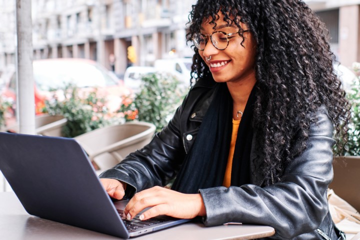 woman working outdoors in a cafe