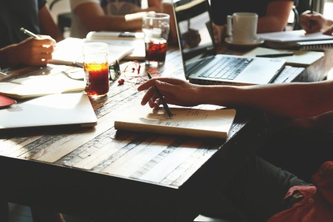 A desk with people studying